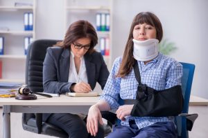 Insurance agent explaining about the liability insurance to injured woman