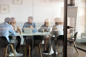 team inside a glass room discussing the best insurance provider