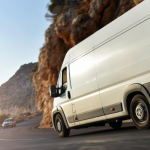 Transit insurance coverage for delivery van transporting goods on South African mountain highway at sunset